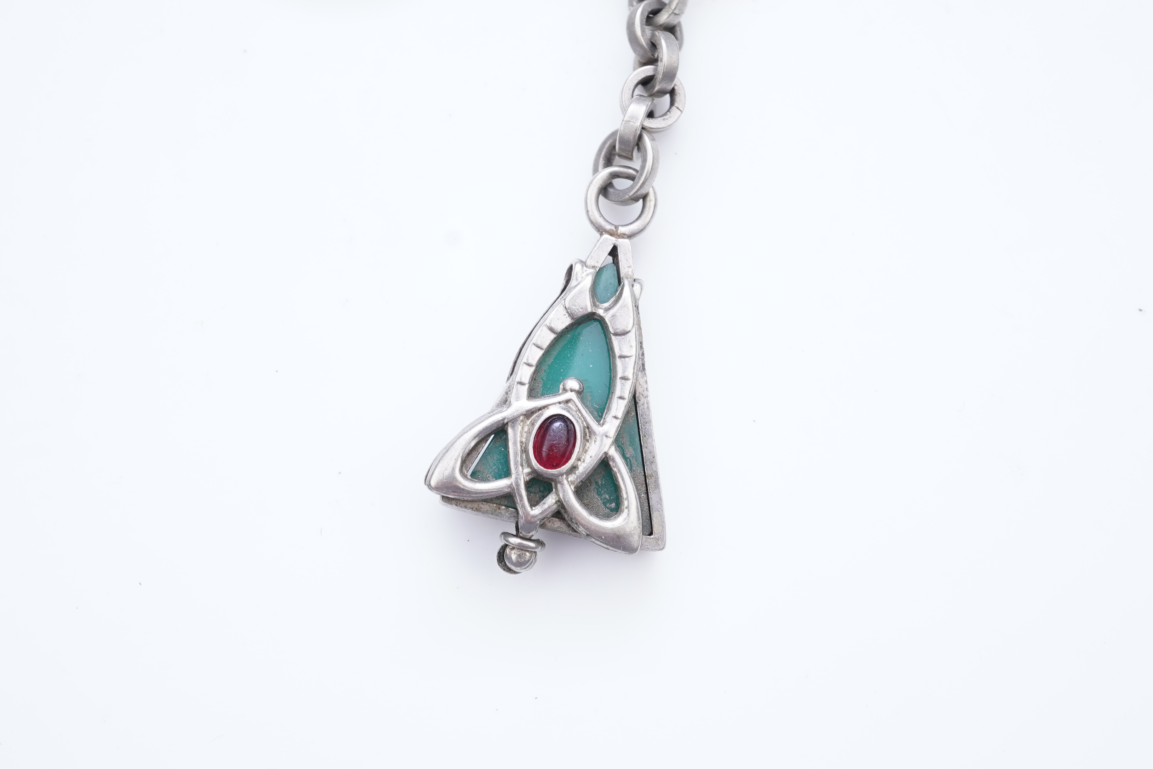 A collection of three silver chains and an Art Nouveau brooch, early 20th century